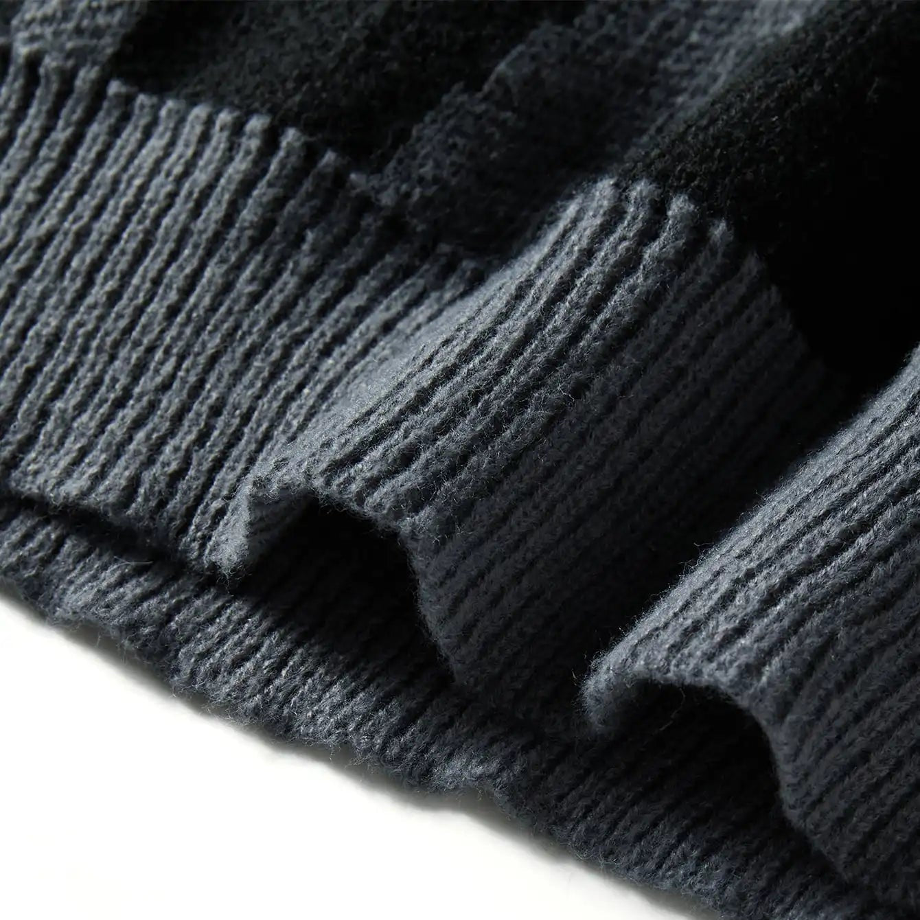 Close-up of dark gray knit fabric on a white background