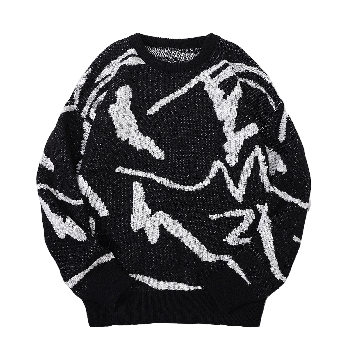 Black sweater with white abstract patterns on a gray surface with sunglasses and a cap.
