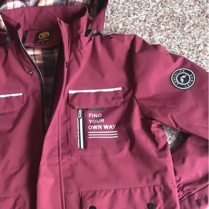 Maroon jacket with visible branding on a speckled surface