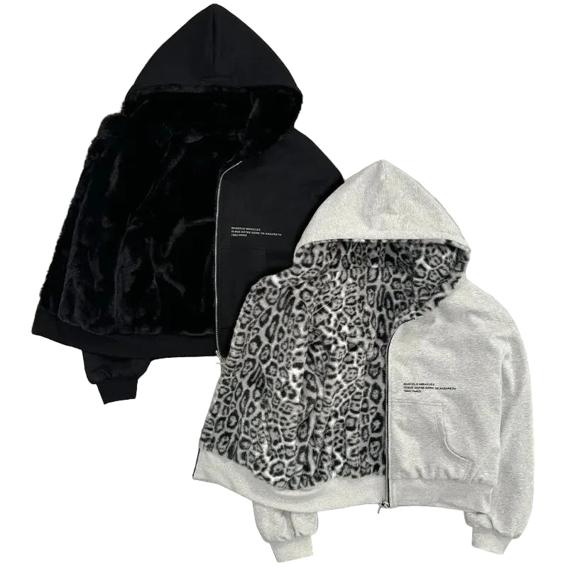 Two hoodies, one black and one with a leopard print pattern, on a gray surface.