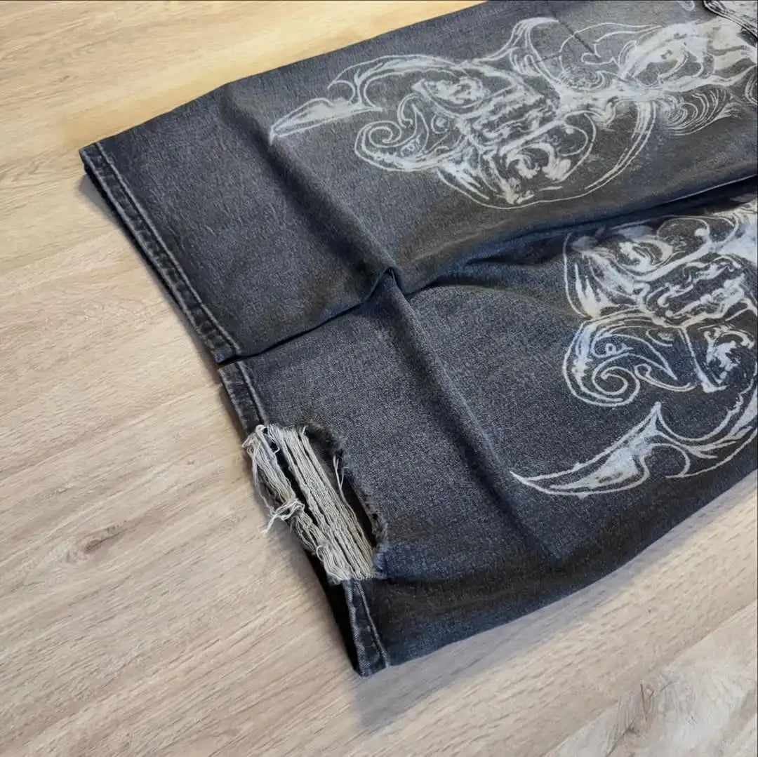 Dark denim fabric with white floral patterns on a wooden surface
