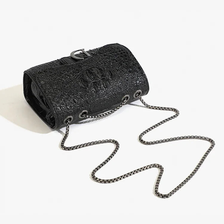 Black textured handbag with chain strap on a white background