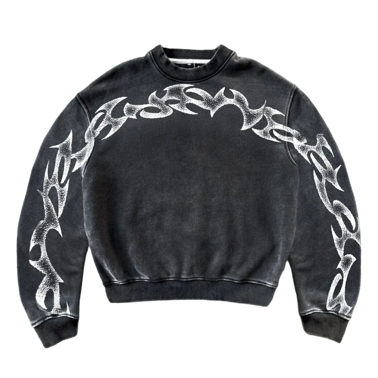 Black sweatshirt with white tribal designs on a gray concrete floor