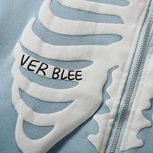 Close-up of a jacket with leaf patterns and 'VER BLEE' text on a light blue background
