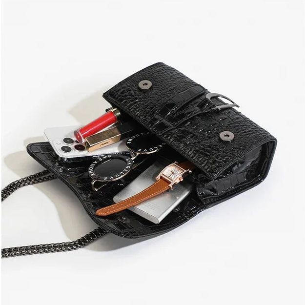 Black leather wallet with various items on a white background