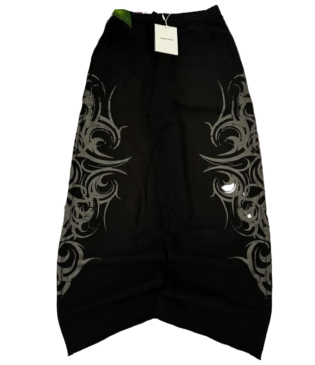 Black skirt with silver tribal patterns on a gray surface