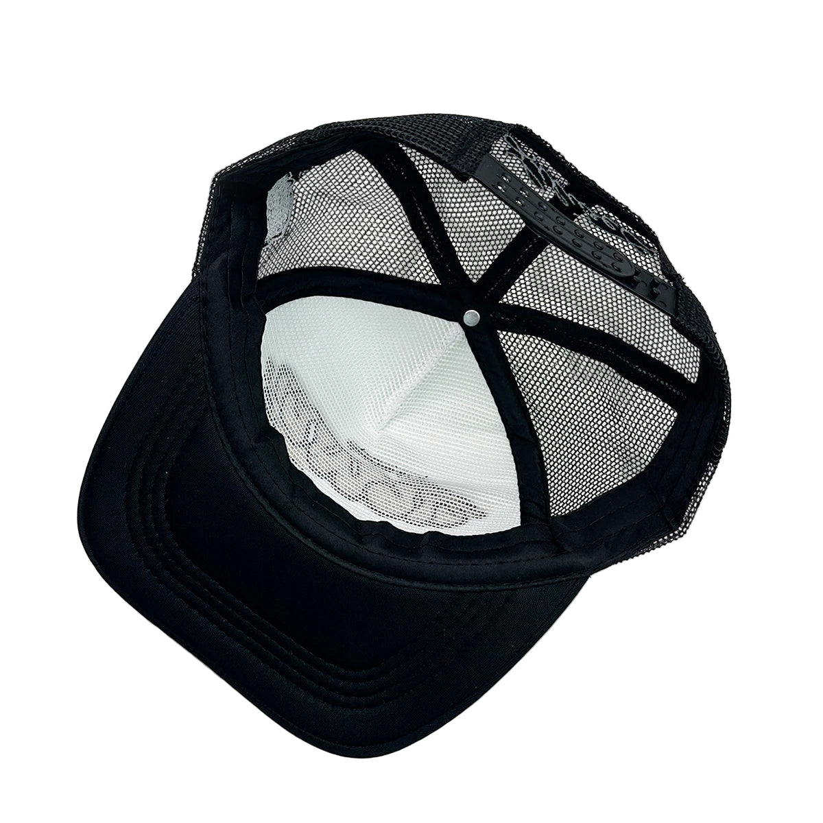 Black mesh cap on a white surface
