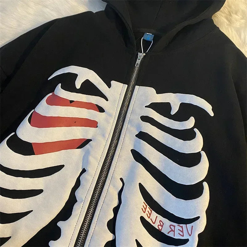 Black hoodie with a white skeleton design on the chest and red and black text on the sleeves.