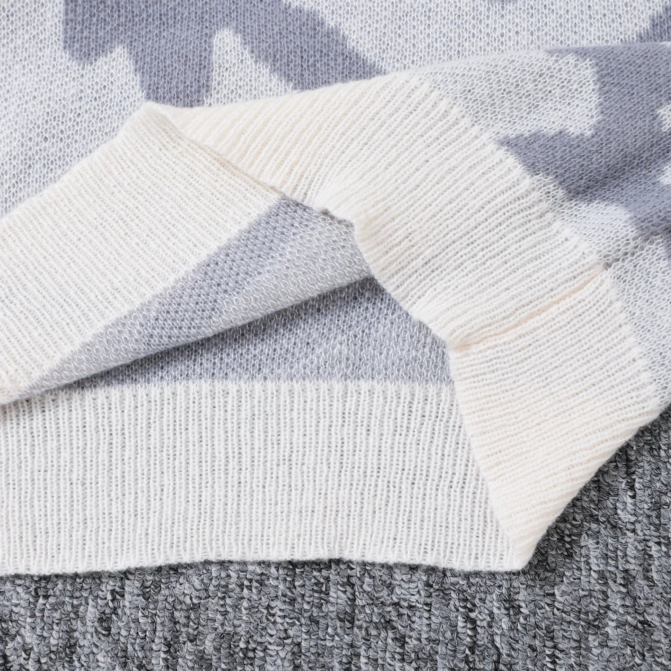 Close-up of a gray and white patterned fabric with a focus on texture.