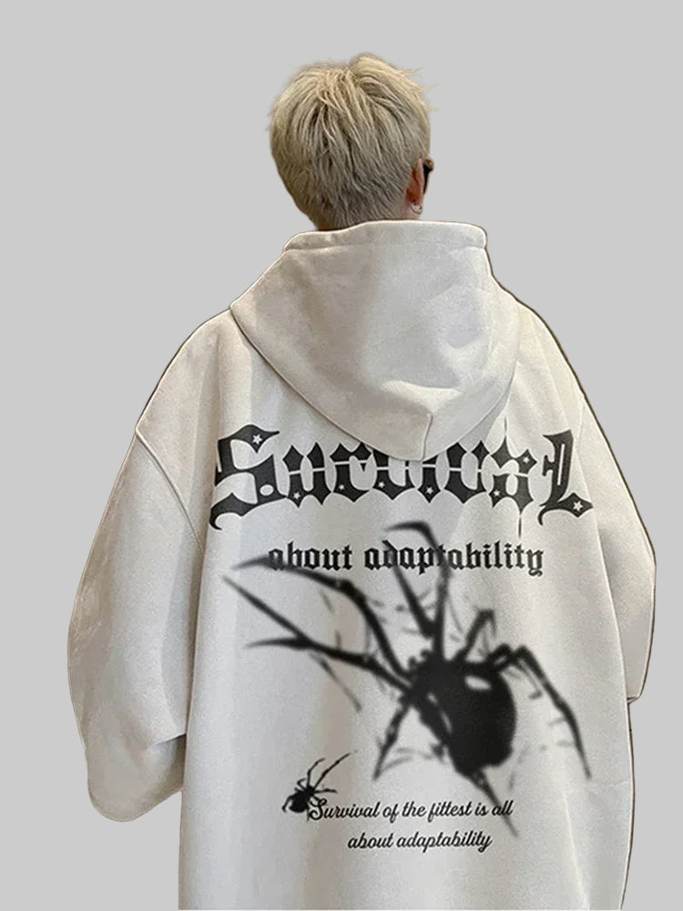 Person wearing a white hoodie with black text and spider design on the back.