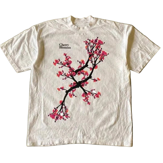 White t-shirt with cherry blossom design on a textured surface