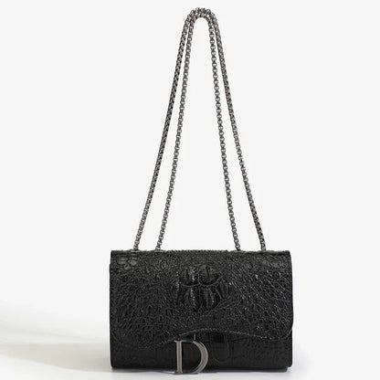 Black textured handbag with chain strap on a white background