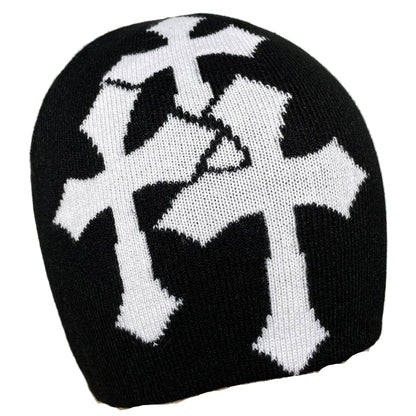 Black knit beanie with white cross design on a gray background