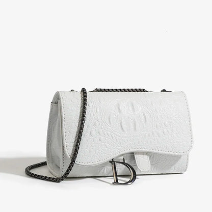 White textured handbag with a chain strap on a light gray background