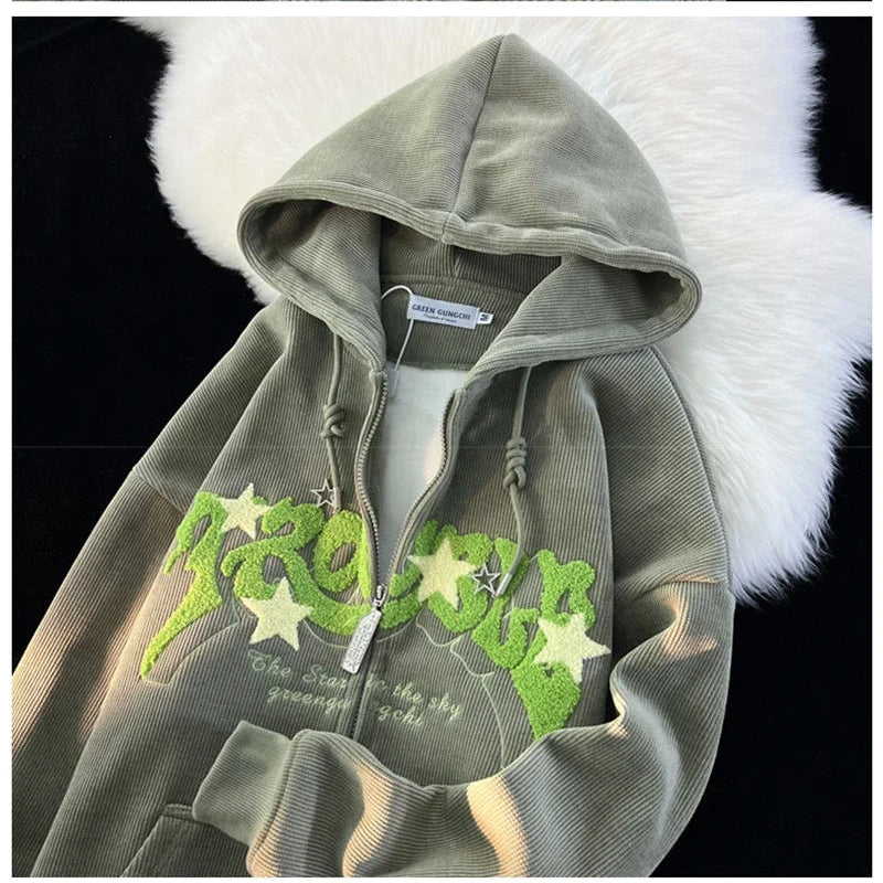 Green hoodie with graphic design on a white fur background