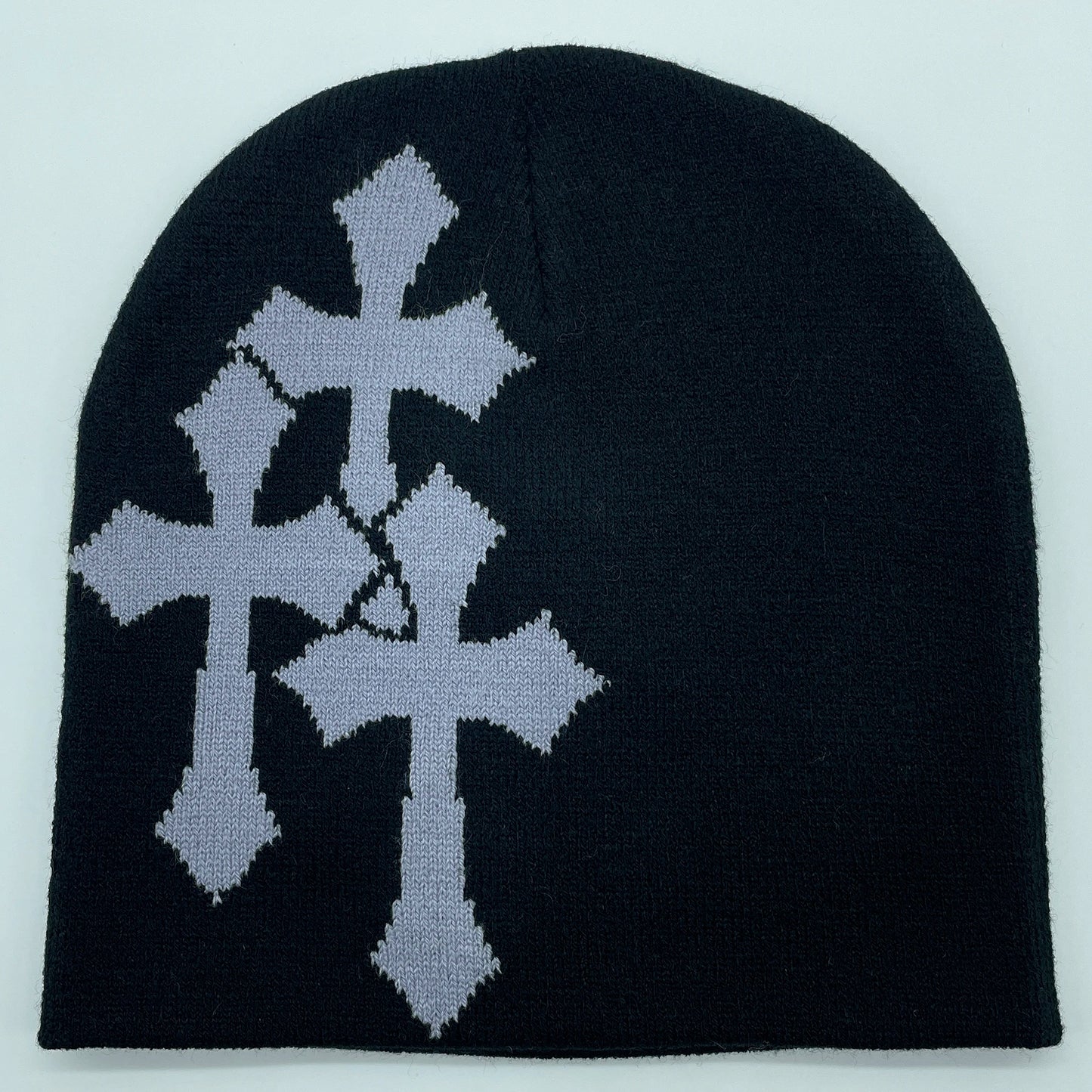 Black beanie with silver cross design on a light gray background