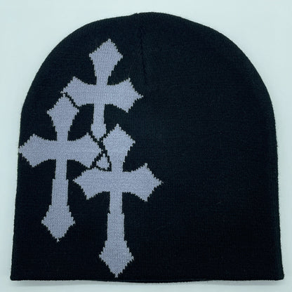 Black beanie with silver cross design on a light gray background
