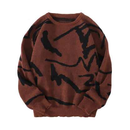 Brown sweater with black abstract patterns on a gray surface