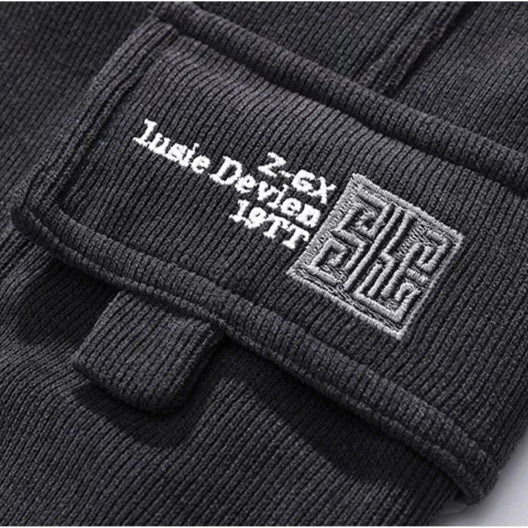 Close-up of a black jacket with branding on a white background