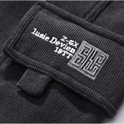 Close-up of a black jacket with branding on a white background