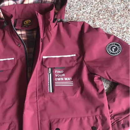 Maroon jacket with visible branding on a speckled surface
