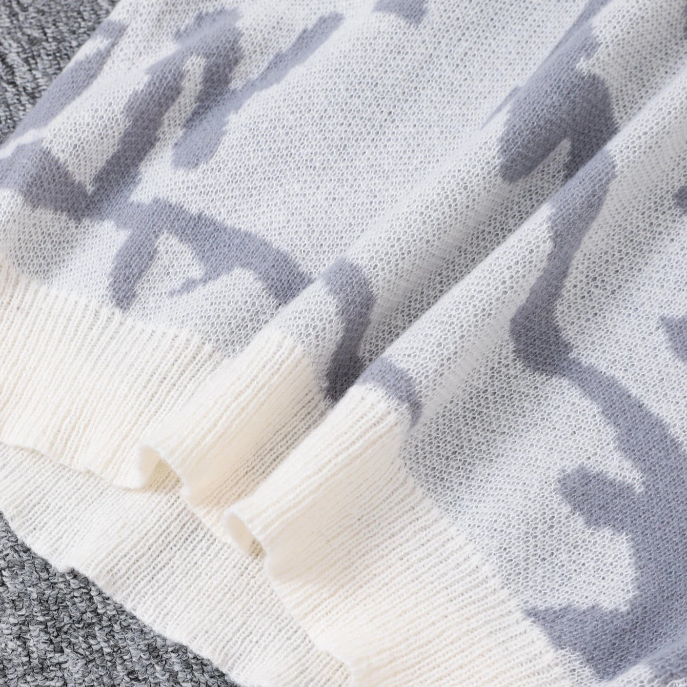 Close-up of a textured fabric with a pattern on a gray background