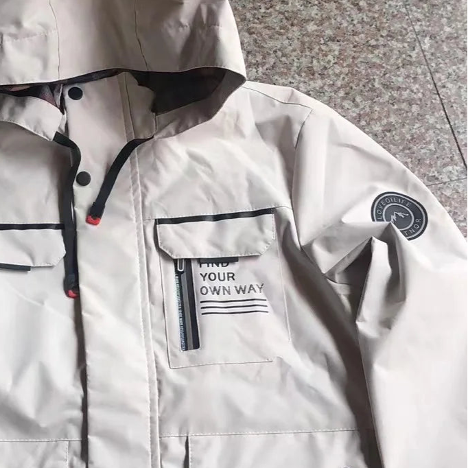 White hooded jacket with black accents on a gray floor