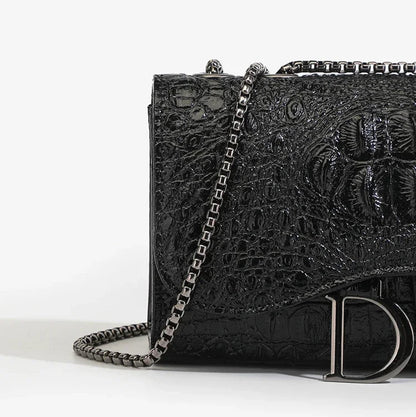 Black textured handbag with chain strap on a white background