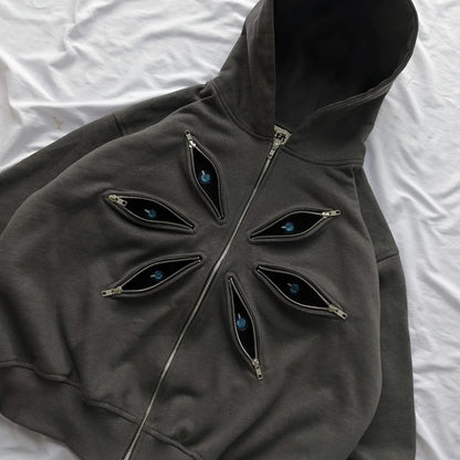 Dark gray hoodie with eye-shaped zippers on a white background