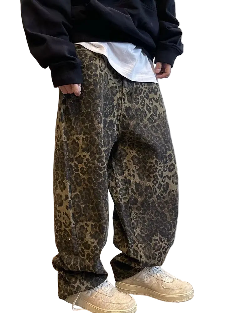 Person wearing leopard print pants and beige shoes against a neutral background