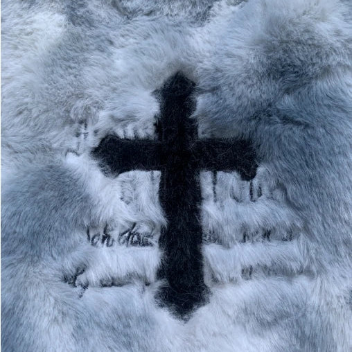 Black cross on a textured white surface