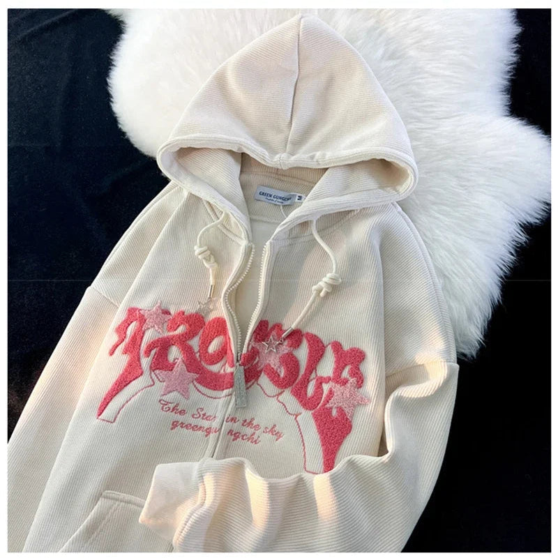 White hoodie with red graphic design on a textured surface