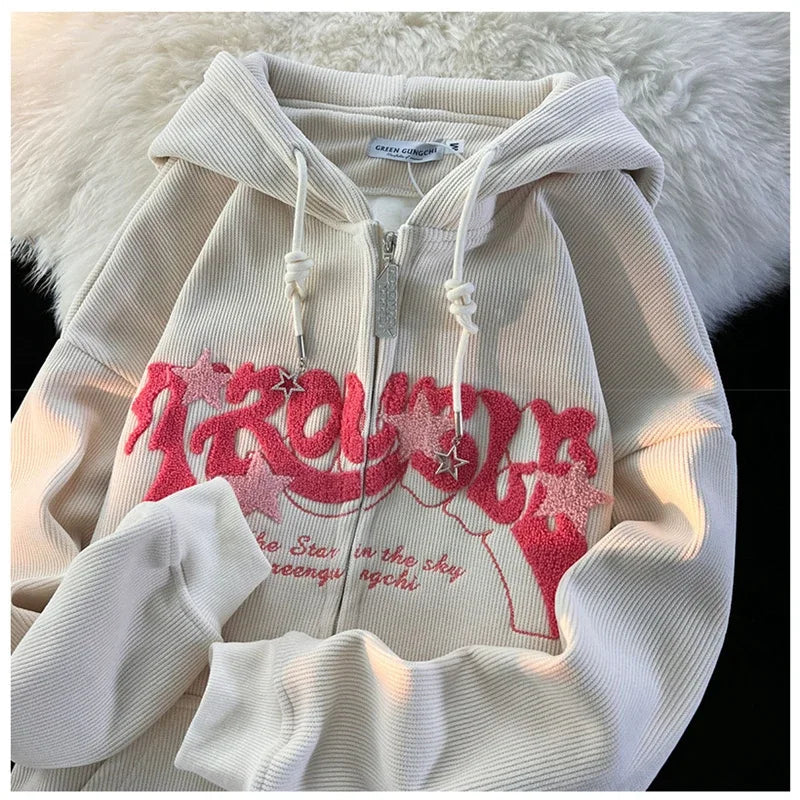 White hoodie with red graphic design on a textured surface