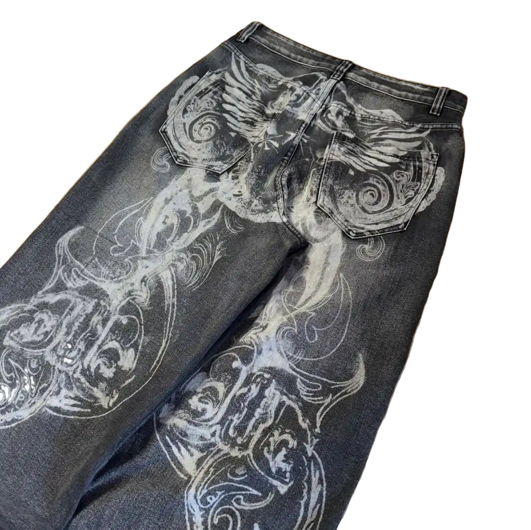 Black jeans with white floral patterns on a wooden floor