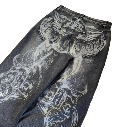Black jeans with white floral patterns on a wooden floor