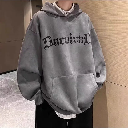 Gray hoodie with 'Survival' text worn by a person against a neutral background