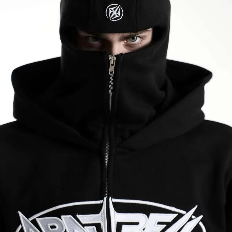Person wearing a black hoodie with a logo on a white background