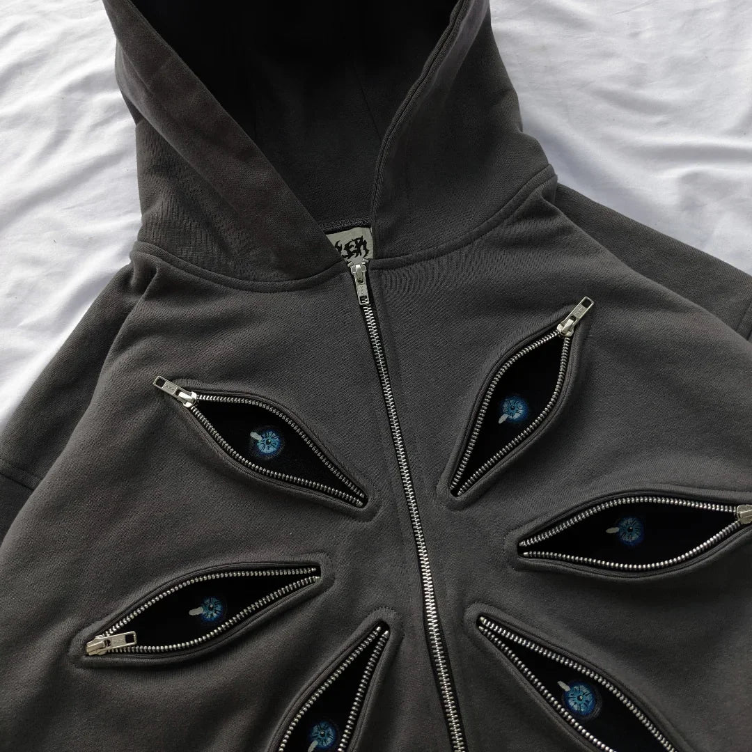 Dark gray hoodie with eye-shaped zippers on a white background