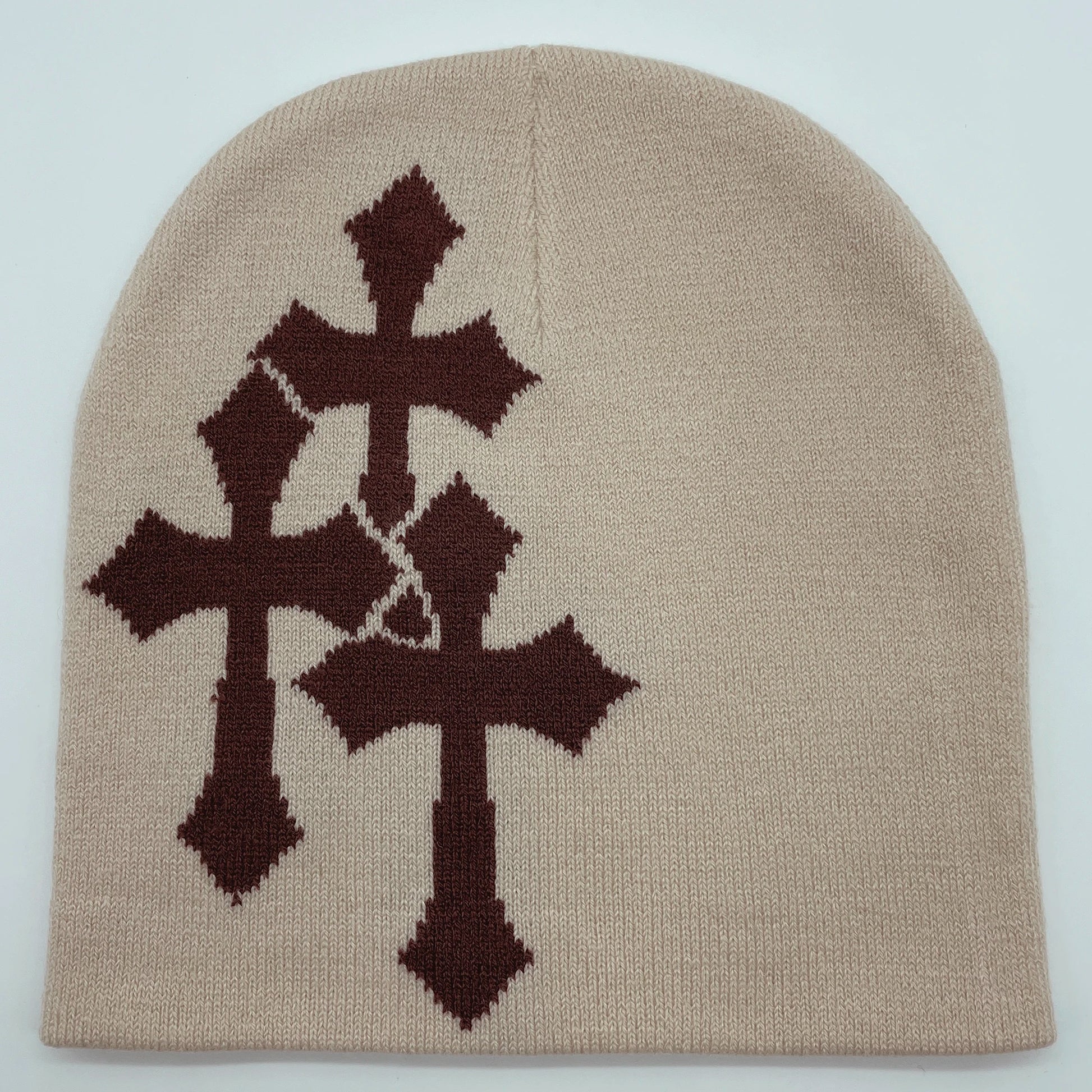 Beige beanie with brown cross patterns on a light gray background