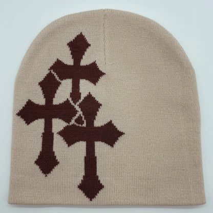 Beige beanie with brown cross patterns on a light gray background