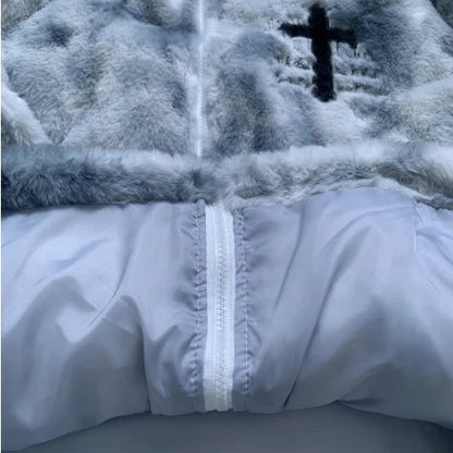 Close-up of a textured fabric with a cross emblem and white zipper.