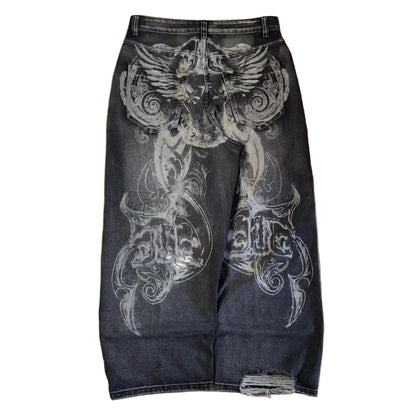 Black jeans with white floral patterns on a wooden floor