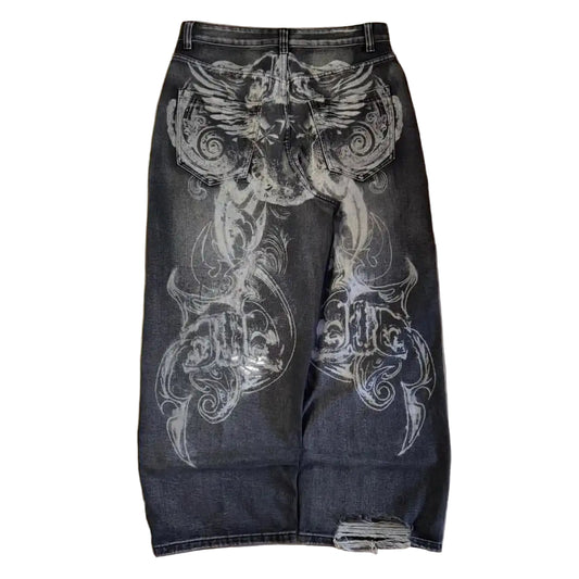 Black jeans with white floral patterns on a wooden floor