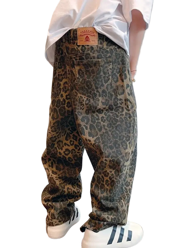 Person wearing leopard print pants with a plain background