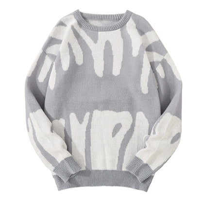 Gray sweater with white abstract patterns on a textured surface