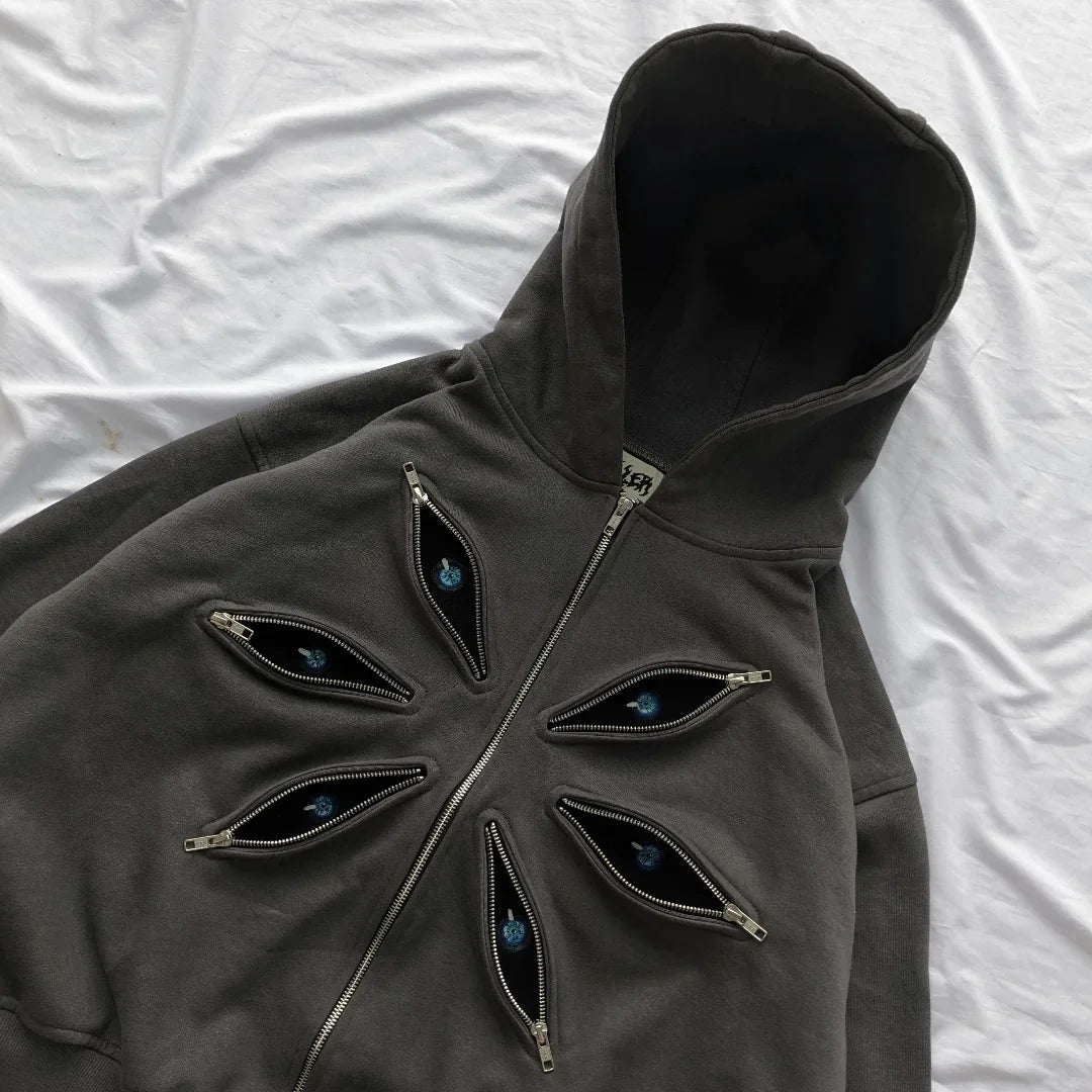 Dark gray hoodie with eye-shaped zippers on a white background