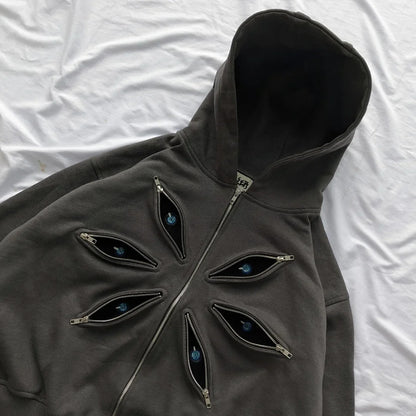 Dark gray hoodie with eye-shaped zippers on a white background