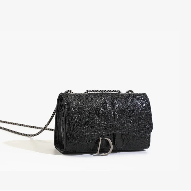 Black textured handbag with chain strap on a white background