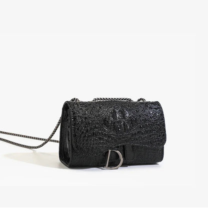 Black textured handbag with chain strap on a white background
