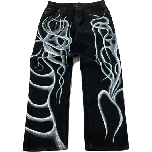 Black jeans with white flame designs on a light gray background